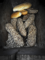 light and dark breads laying in a wooden box
