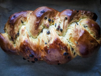 a freshly baked, shiny raisin braid