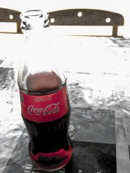 a coca cola in a glassbottle serve as a refreshment