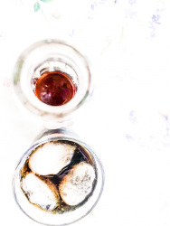 coca cola in a glassbottle and with ice cubes in a drinkglass