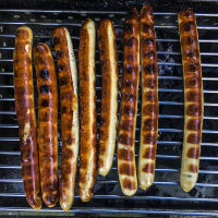 some long sausages ready grilled on the grill