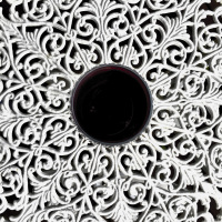 a glass of red wine in the middle of a white tabel of cast iron