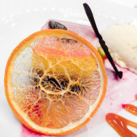 a sweet light pink dessert decoraded with a dry orange slice