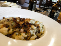 a hearty czech meal on a white plate and a bottle of the czech cola named royal crown
