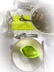 a festive table d\'hote with green serviettes and a big soup tureen