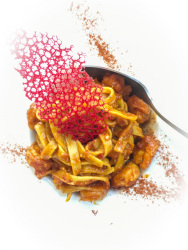 a portion tagliatelle with a red filigree decoration on it