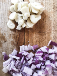 cutting garlic and onions for preparing greek chorta