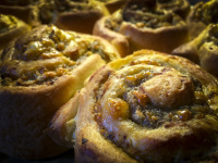 with minced meat and tomatoes filled dough snails are roasting in oven