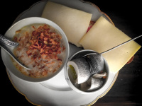 onionsoup, cheese sandwiches and a rolled pickled herring on a plate with gold rim