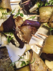 little eggplant skewers filled with feta and cress on the top