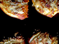 four freshly baked lye rolls with sesam on a dark wooden table