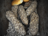 light and dark breads laying in a wooden box