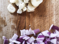 cutting garlic and onions for preparing greek chorta