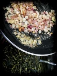 to sear the cutted garlic and onions in butter for preparing greek chorta