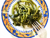 delicious greek chorta on a plate with a fork ready to eat it