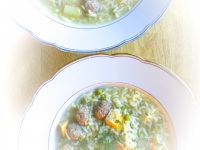 two gold rimmed plates are filled with typical german wedding soup