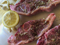 ready preparated lamb chops with a lemon and with some garlics