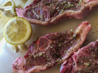 ready preparated lamb chops with a lemon and with some garlics