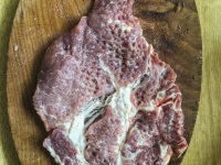 a pounded neck staeak is ready for spices and for the grill