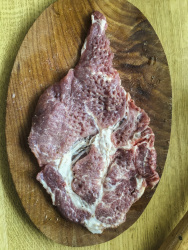 a pounded neck staeak is ready for spices and for the grill