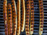 some long sausages ready grilled on the grill