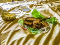 a fast picknick with black bread and margarine on the bed