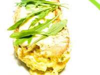 a slice of bread with egg and cheese and arugula on the top for a little picknick