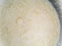 greek trachana cooks with water and butter in a cooking pot