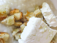 the last top for the greek trachana with peaces of white bread is fresh feta on the top
