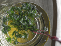 in a bowl with sparkling wine is hanging a bunch of sweet woodruff to make a punch