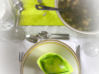 a festive table d\'hote with green serviettes and a big soup tureen