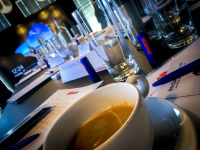 a half full cup of coffee and some glasses of water at a meeting