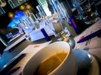 a half full cup of coffee and some glasses of water at a meeting