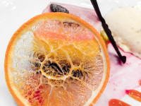 a sweet light pink dessert decoraded with a dry orange slice