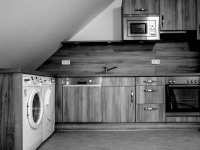 a new wooden kitchen in a facility for the disabled, black-and-white