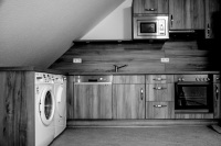 a new wooden kitchen in a facility for the disabled, black-and-white