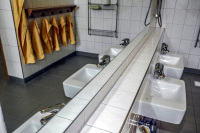 small washbasins and orange towels in a bathroom in a kindergarden