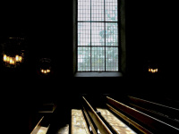 wooden church pews in front of big church windows in st. peter paul in hermannsburg in lower saxony