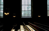 wooden church pews in front of big church windows in st. peter paul in hermannsburg in lower saxony