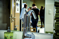 the water tap of a washroom in a kindergarden in front of a mirror