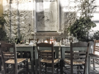 a gastronomic idyll of the tavern saita in athens with chairs and tables where many people eating before