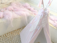 a pink decoration with a small tent, sandales and tulle cloths at a greek baptism on tsambika on rhodes