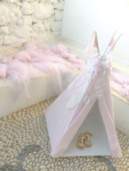 a pink decoration with a small tent, sandales and tulle cloths at a greek baptism on tsambika on rhodes