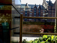 behind a metal fence you see the building of the hamburg dungeon in the speicherstadt hamburg
