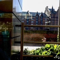 behind a metal fence you see the building of the hamburg dungeon in the speicherstadt hamburg