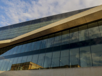 the sky is reflected in the facade of the acropolis museum in makriyanni in athens