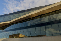the sky is reflected in the facade of the acropolis museum in makriyanni in athens