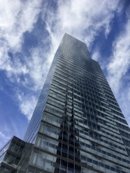 the kölnturm in cologne with a blue sky and some clowds