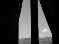 view out of a window in the residenza ducale in bovino to the hilly landscape of puglia, black-and-white
