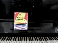 a black piano with a colorful song book ot the greek composer giannis spanos in the lounge of the hotel elafos on rhodes